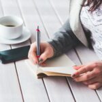 woman writing in journal